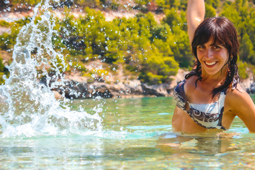 Lifestyle, a young woman in a bikini bathing on the Croatian coast