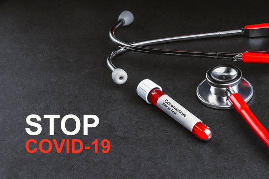 STOP COVID-19 text with stethoscope and blood sample vacuum tube on black background. Covid or Coronavirus Concept