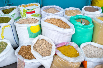 bags of condiments in the Eastern market. the bags stand close together.