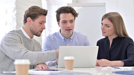 Young Team Working on Laptop in Office