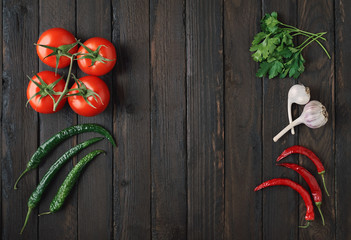 Fresh vegetables laid out on an old wooden background with copy space.