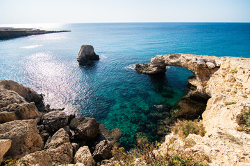 Beautiful sunset at natural stone bridge near Ayia Napa on Cyprus, Europe. Love bridge. Cavo greco.