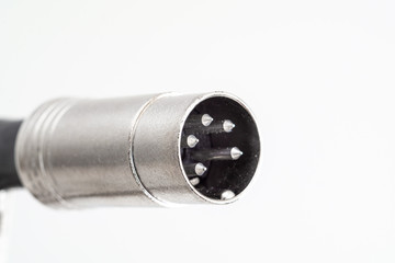 XLR din plug connector close up shot with visible connection pins isolated on white
