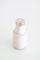 White ceramic electrical fuse cartridge with metal tip close up macro shot isolated on white