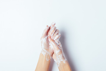 Woman thoroughly washing her hands with soap