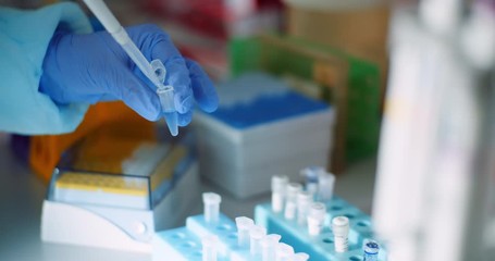 female scientist injecting liquid or virus into flask in laboratory - Powered by Adobe