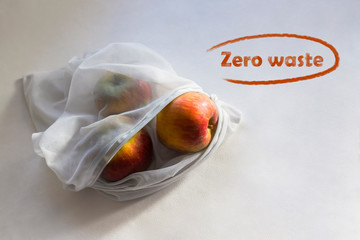 Apples in reusable fruit pouch in the sunlight with shadows