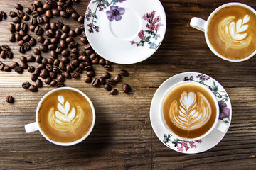 Flat lay barista latte art coffee cappuccino with roasted robusta coffee beans