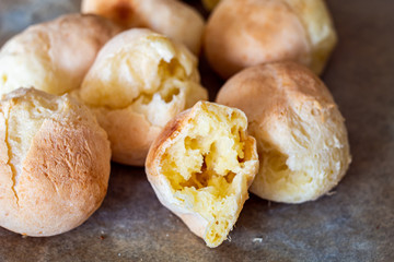 Pao di queijo small cheese breads fresh out of the oven front piece opened up shallow depth of field warm light