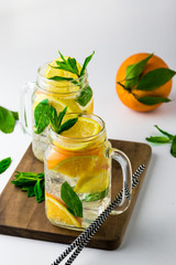 Fresh homemade herbal lemonade with lemon orange and mint and soda water