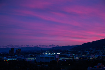 Beautiful sunset sky with pink and purple fiery clouds over Zurich city Switzerland