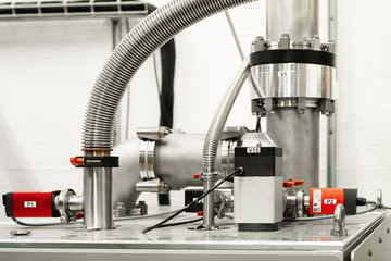 Science laboratory industrial size metal piping cables and digital electronic measurement equipment experiment setup