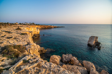Fototapeta na wymiar Ayia Napa, Cyprus landscape with beautiful love rock bridge on mediterranean sea at sunset