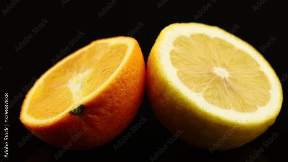 Wall mural lemon and orange fruit black background