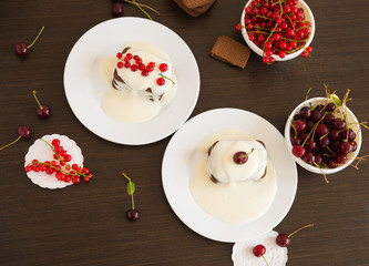 Sweet dessert. Chocolate cookies with a sweet vanilla sauce and fresh cherries, red currant berries