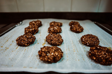 Cooking cookies at home based on healthy ingredients like banana, chocolate and oatmeal. Shaping cookies before putting them in the oven. Lifestyle