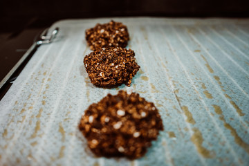 Cooking cookies at home based on healthy ingredients like banana, chocolate and oatmeal. Shaping cookies before putting them in the oven. Lifestyle