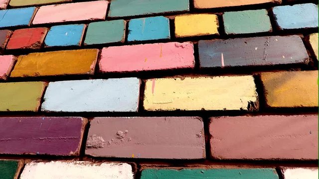 background, texture, brick wall painted with paint of different bright colors
