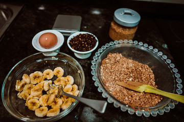 Process of mixing healthy and natural ingredients to cook at home some oatmeal, chocolate and banana cookies without refined sugar. Real food. Lifestyle