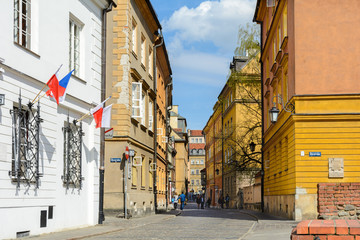 Warsaw Old city. Houses and city wall. Earthworks. Red brick city wall. Small street, Rycerska street, in the medieval old city in Warsaw. The oldest historical district of Warsaw