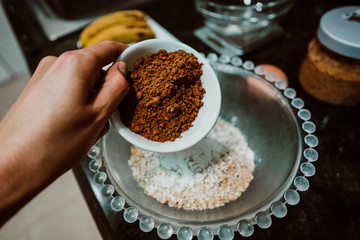 Process of mixing healthy and natural ingredients to cook at home some oatmeal, chocolate and banana cookies without refined sugar. Real food. Lifestyle