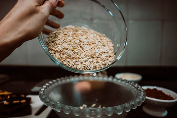 Process of mixing healthy and natural ingredients to prepare at home some oatmeal, chocolate and banana cookies without refined sugar. Real food. Lifestyle