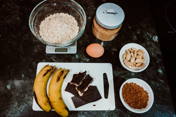 Selection of healthy and natural ingredients to prepare at home some oatmeal, chocolate and banana cookies without refined sugar. Real food. Lifestyle