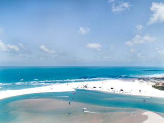 Aerial view of people kitesurfing in a amazing beach, sunny day,  Brazil . 