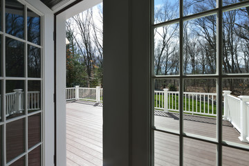 Garden deck view through the window glass. French door opening to a new deck.