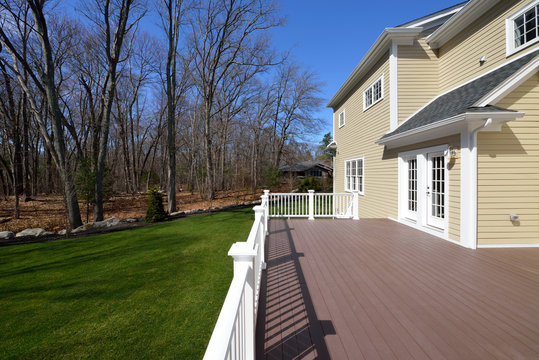 Large composite deck on colonial style house.
