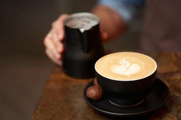 Barista making cappuccino, close-up