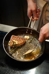 Chef cooking duck breast, close-up. Grilled poultry meat