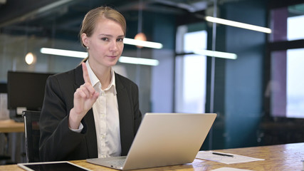 Young Businesswoman saying No by Finger in Office