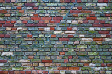 multicolored brick wall of an old building, background