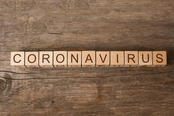 Coronavirus word on wooden toy cubes.  New official Coronavirus name adopted by World Health Organisation is COVID-19