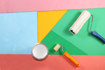 Can of paint for repair on a multi-colored painted background. Banner for the shop, geometry....
