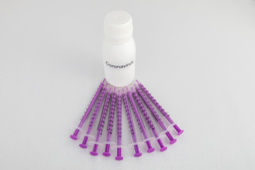 white bottle of coronavirus with syringes