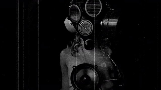 Woman wearing gas mask and speakers.