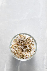 salt with dry herbs in small bowl on ceramic background