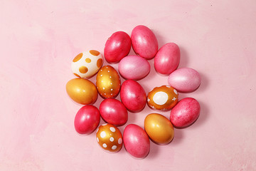 Decorated golden easter eggs on a pink background. Minimal holiday concept. Happy Easter background, place for text, postcard, banner for the screen.