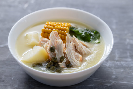 soup potato with corn and chicken in white bowl on ceramic background