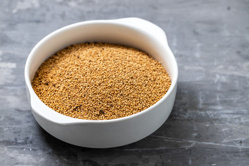 quinoa on white bowl on ceramic background