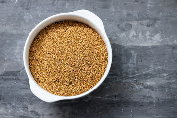 quinoa on white bowl on ceramic background