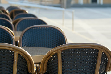 Empty cafe tables and chairs on the street