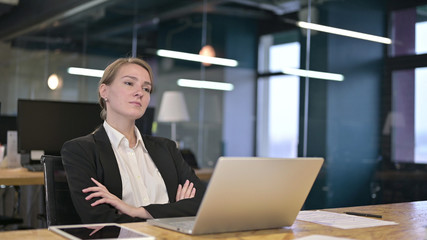 Serious Young Businesswoman Thinking in Office