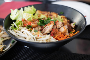 chinese salad in black bowl in restaurant