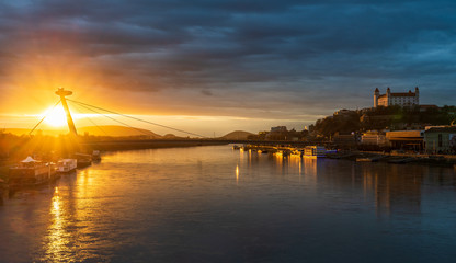 Bratislava castle and UFO restaurant during sunset under cloudy weather.