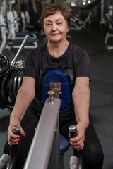 elderly woman goes in for sports in a fitness club
