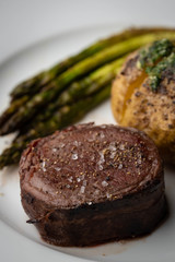 bacon wrapped tenderloin steak on white plate