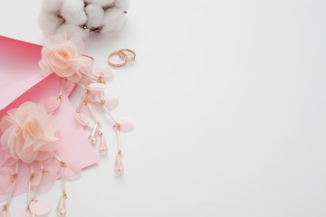 Wedding text background, white, decorated with pink invitation envelopes, top view, with copy space. The concept of a wedding date or a gentle background for the bride.